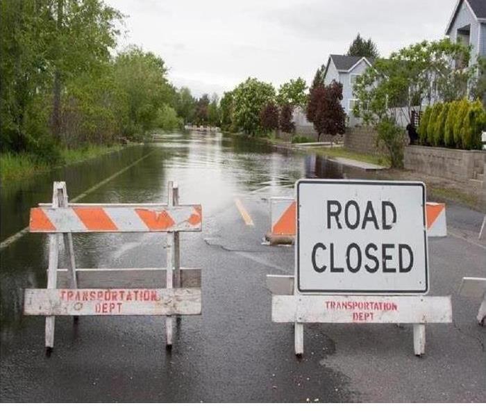 flooded street with signs and baracades