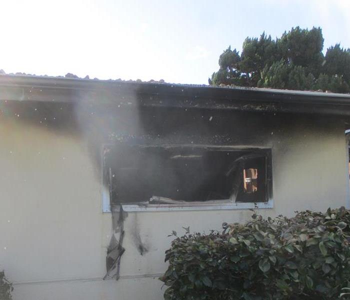 Smoke and fire damaged home in Tarzana, CA