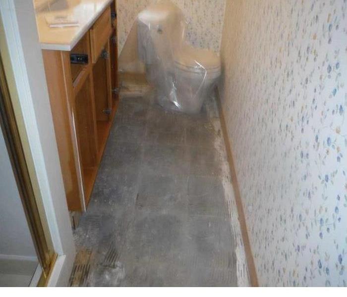 water damaged bathroom with toilet removed